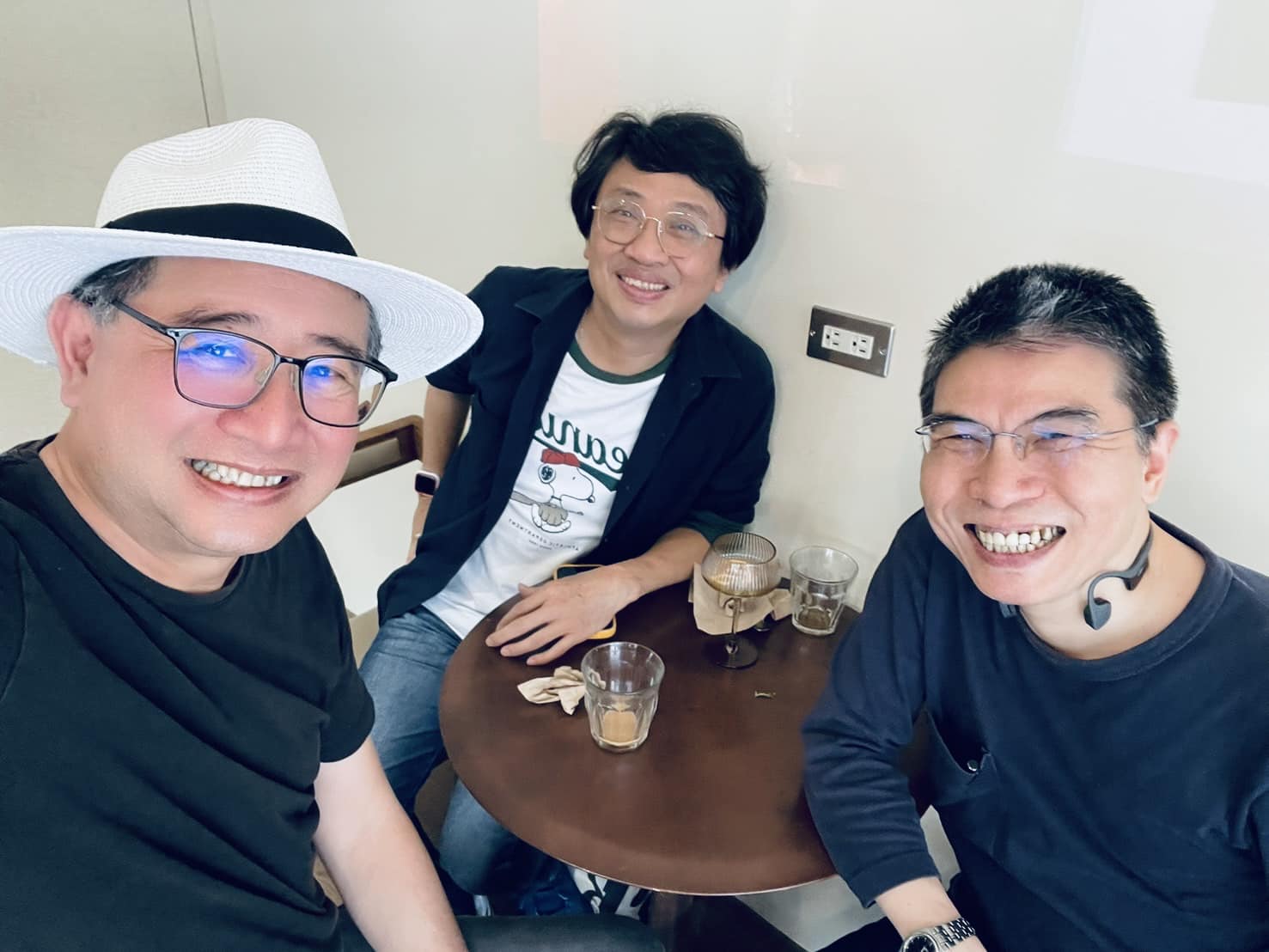 May be an image of 3 people, hat and text